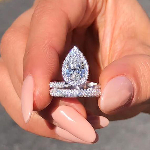 Attractive Twist Halo Pear Cut Engagement Ring in Sterling Silver